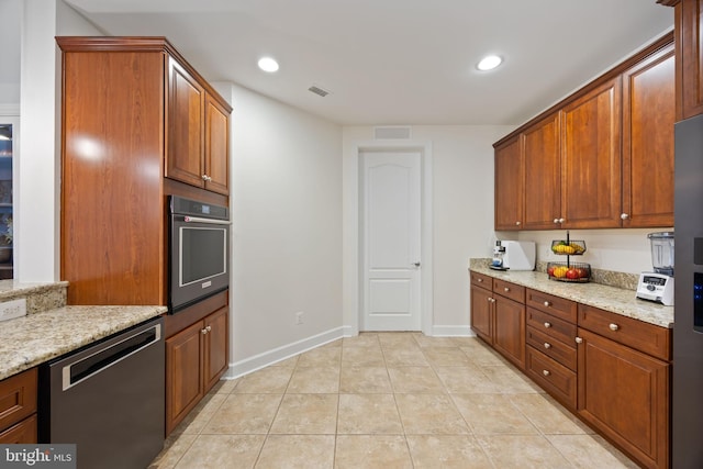 kitchen with visible vents, dishwashing machine, light tile patterned floors, and oven