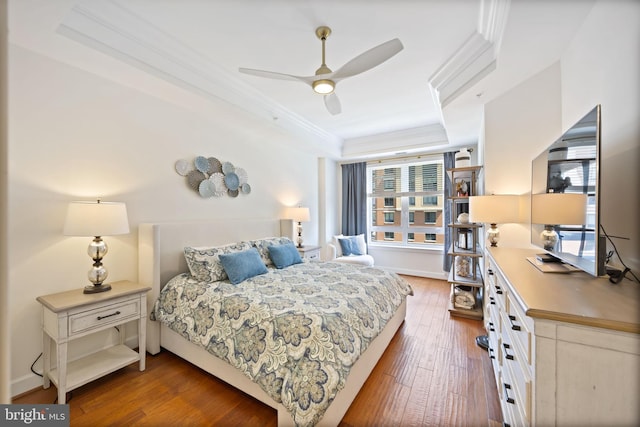 bedroom featuring crown molding, multiple windows, wood-type flooring, and ceiling fan
