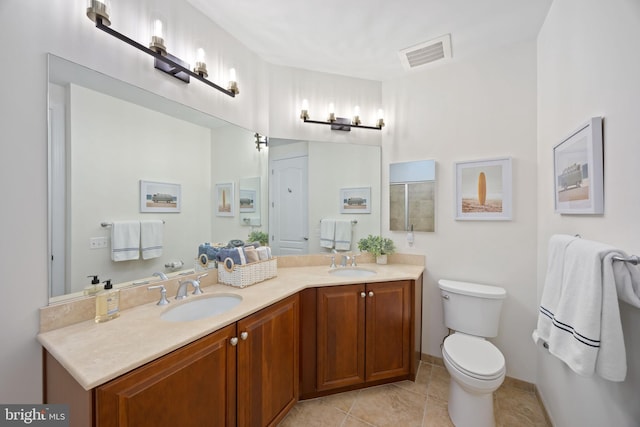 full bathroom featuring a sink, tile patterned floors, toilet, and visible vents