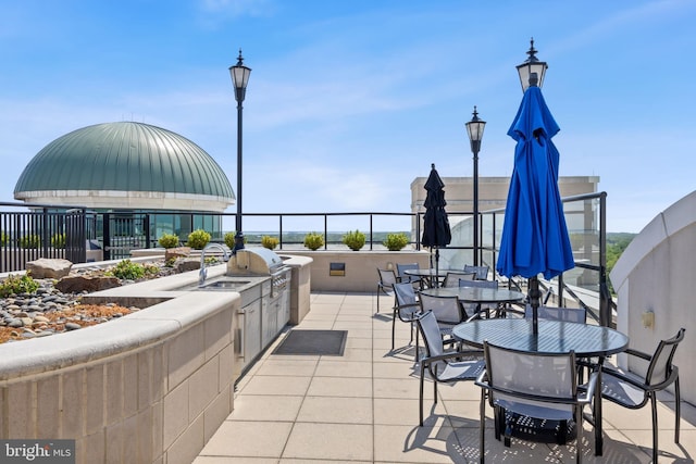 view of patio / terrace with outdoor dining space and exterior kitchen