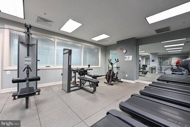 exercise room featuring visible vents and baseboards