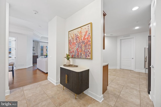 hallway with recessed lighting, baseboards, visible vents, and light tile patterned floors