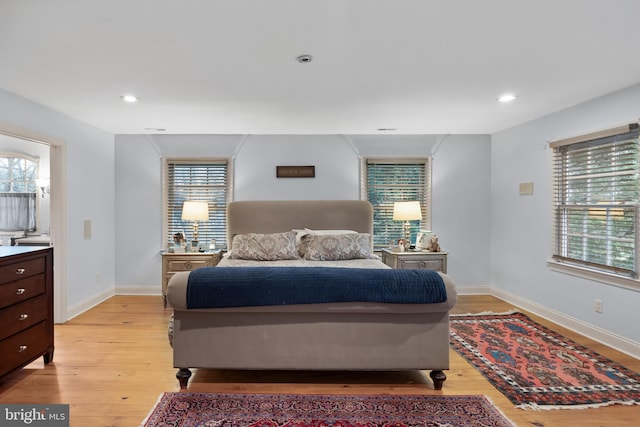 bedroom with recessed lighting, baseboards, and light wood-type flooring