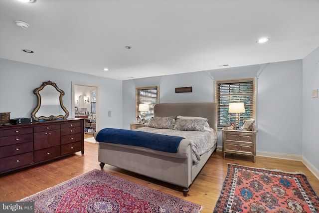 bedroom with light wood finished floors, recessed lighting, multiple windows, and baseboards