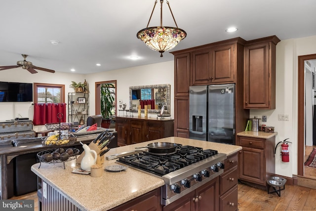 kitchen featuring recessed lighting, light wood-style floors, ceiling fan, appliances with stainless steel finishes, and open floor plan