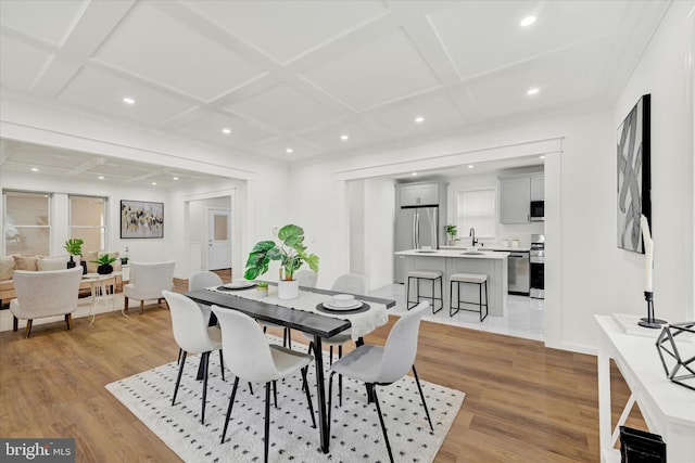 dining space with coffered ceiling, light wood-style floors, and recessed lighting