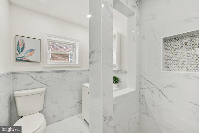 bathroom with tile walls and toilet