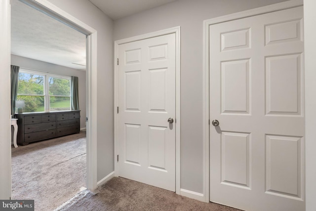 interior space featuring carpet flooring and baseboards