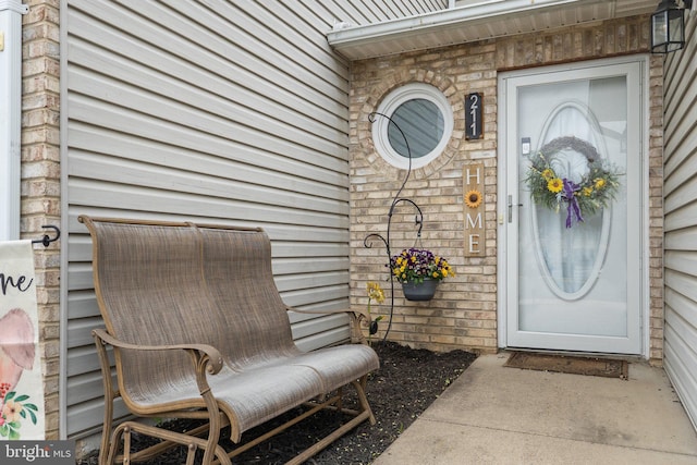 view of exterior entry featuring brick siding