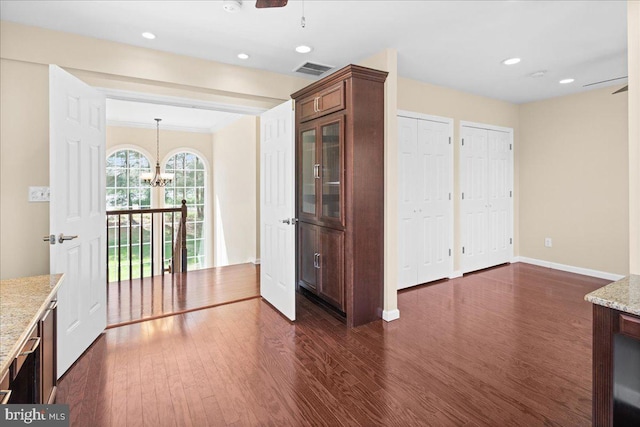 5 Klockner Ct, Lawrence Township, NJ 08648 - unfurnished dining area featuring visible vents, baseboards, ceiling fan with notable chandelier, and dark wood-style floors