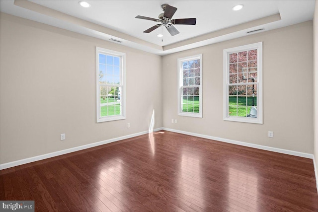 5 Klockner Ct, Lawrence Township, NJ 08648 - spare room featuring visible vents, a tray ceiling, plenty of natural light, and wood finished floors