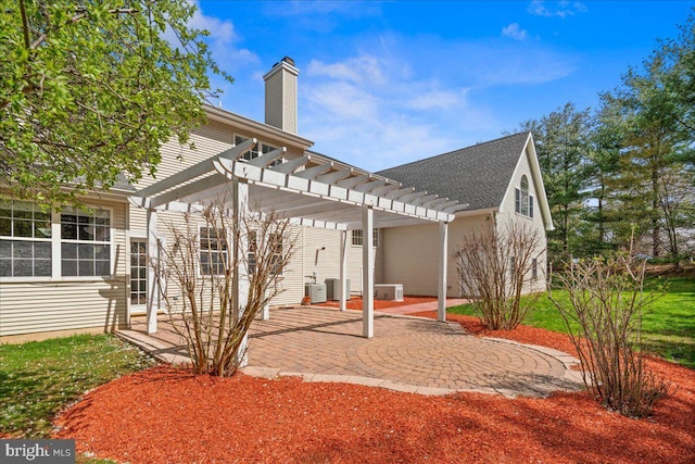 5 Klockner Ct, Lawrence Township, NJ 08648 - back of house with a patio, a chimney, a pergola, cooling unit, and a shingled roof
