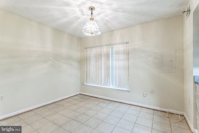 empty room with baseboards, electric panel, and a notable chandelier
