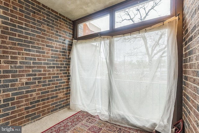 interior space featuring brick wall