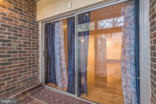 view of exterior entry with brick siding