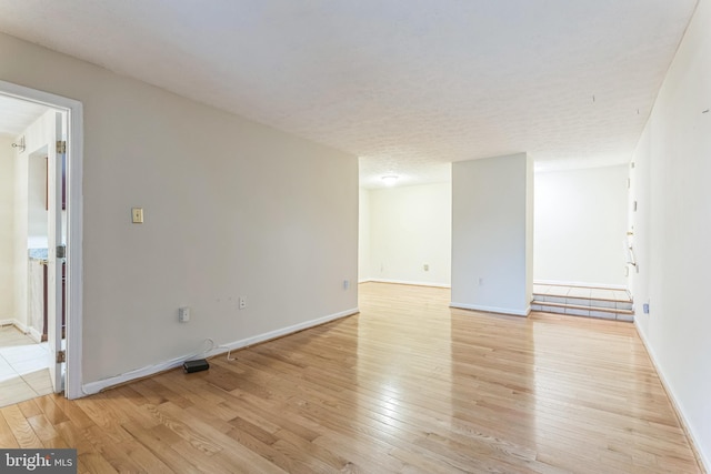 interior space with light wood-style floors and baseboards