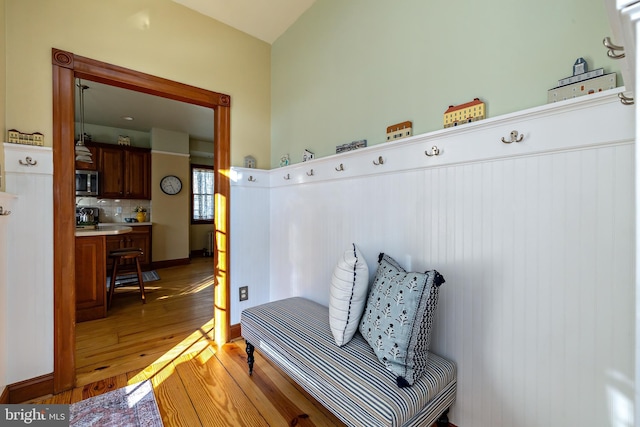 mudroom featuring light wood finished floors and baseboards