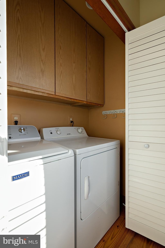 washroom featuring cabinet space and separate washer and dryer