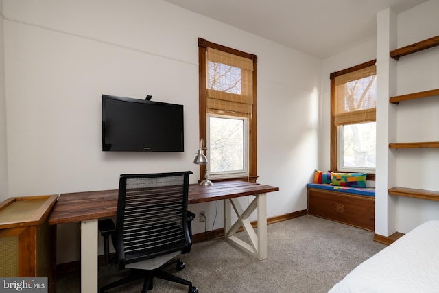 carpeted office featuring baseboards