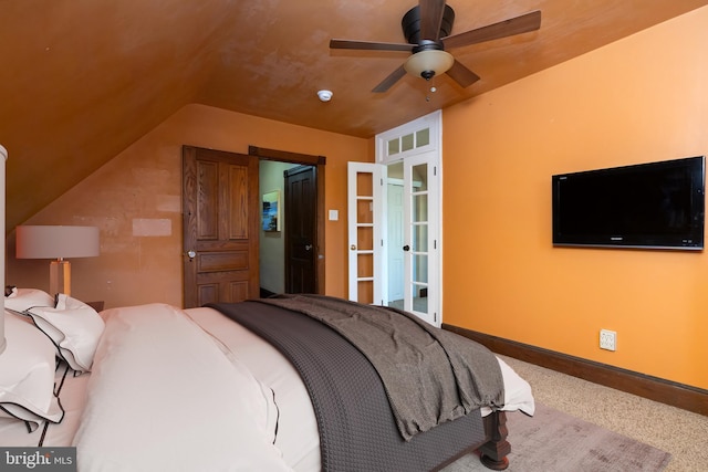 bedroom featuring lofted ceiling, carpet floors, and baseboards