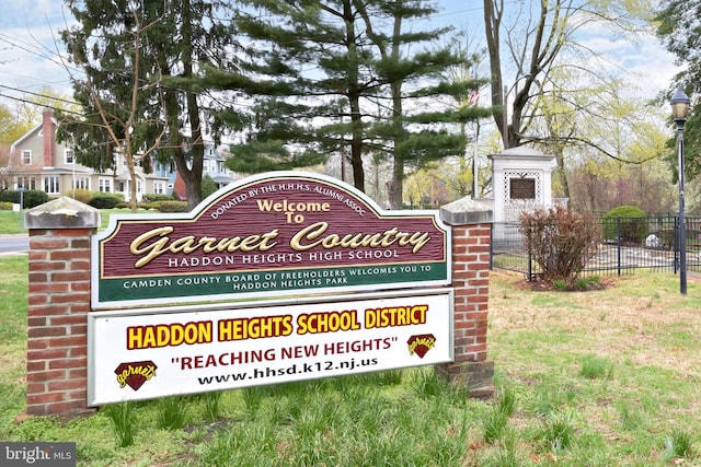community sign featuring fence