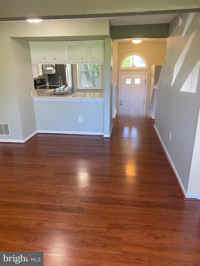 entryway featuring dark wood-style floors and baseboards