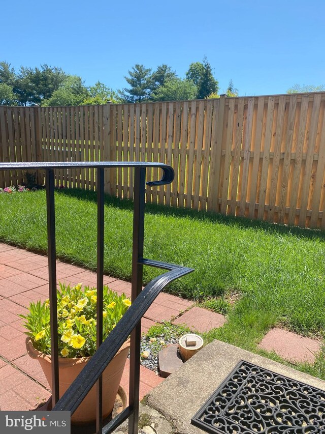 view of yard featuring fence and a patio area