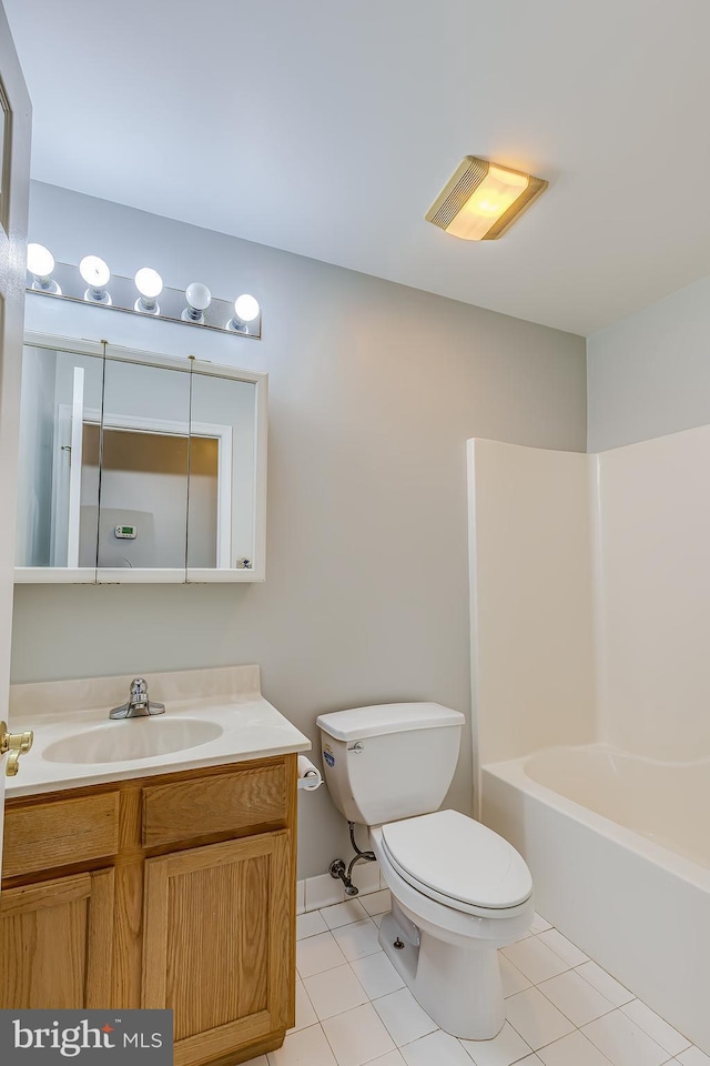bathroom with toilet, tile patterned floors, and vanity