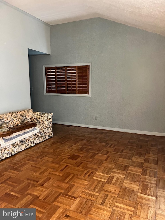 interior space with baseboards and lofted ceiling