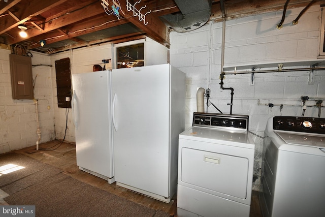 washroom with laundry area, washing machine and dryer, and electric panel