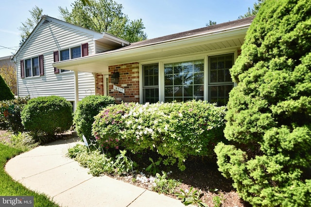 tri-level home featuring brick siding