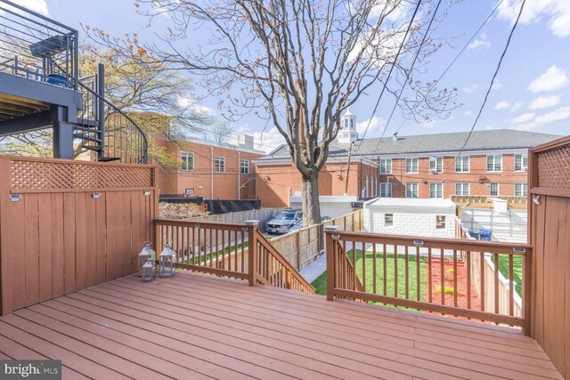 deck with a fenced backyard, stairs, and a residential view