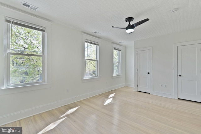 unfurnished bedroom featuring baseboards, light wood-style flooring, and visible vents