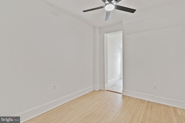 spare room featuring baseboards, a ceiling fan, and hardwood / wood-style flooring