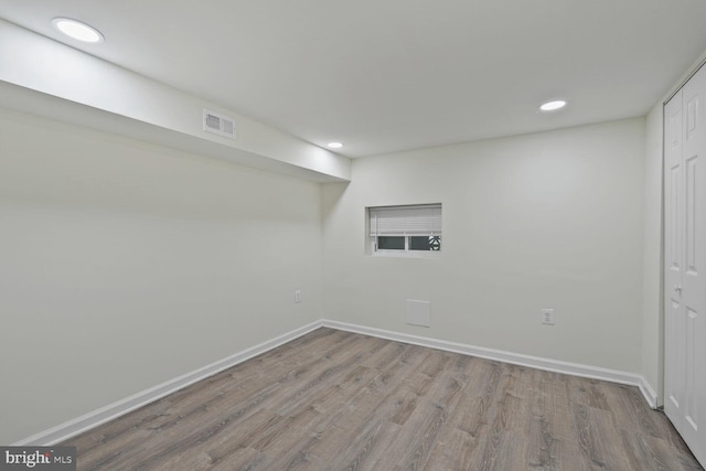 finished basement featuring recessed lighting, wood finished floors, visible vents, and baseboards