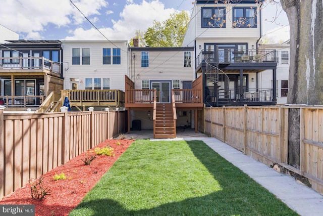 back of house with central AC unit, a fenced backyard, a yard, a wooden deck, and stairs
