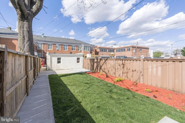 view of yard with a patio area and a fenced backyard