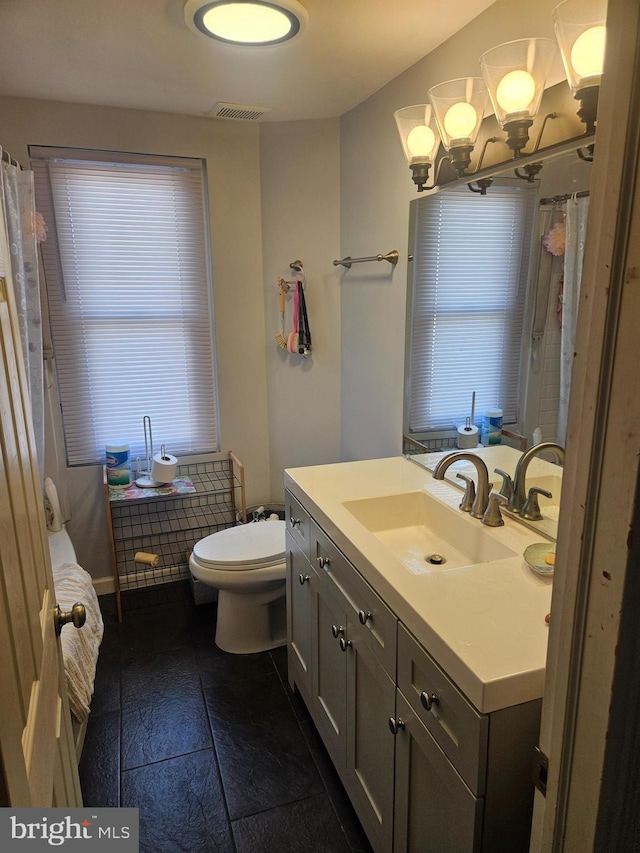 137 Washington Ave, Downingtown, PA 19335 - bathroom featuring visible vents, toilet, vanity, and a notable chandelier