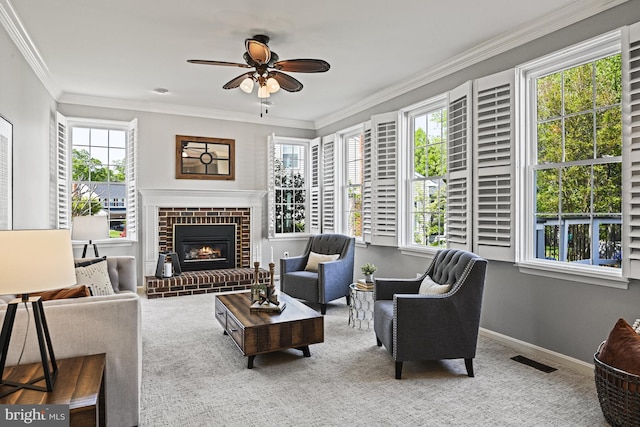 815 Kenneth Pl SE, Leesburg, VA 20175 - carpeted living area featuring a brick fireplace, crown molding, visible vents, baseboards, and ceiling fan