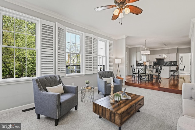 815 Kenneth Pl SE, Leesburg, VA 20175 - living area featuring light colored carpet, crown molding, baseboards, and a ceiling fan