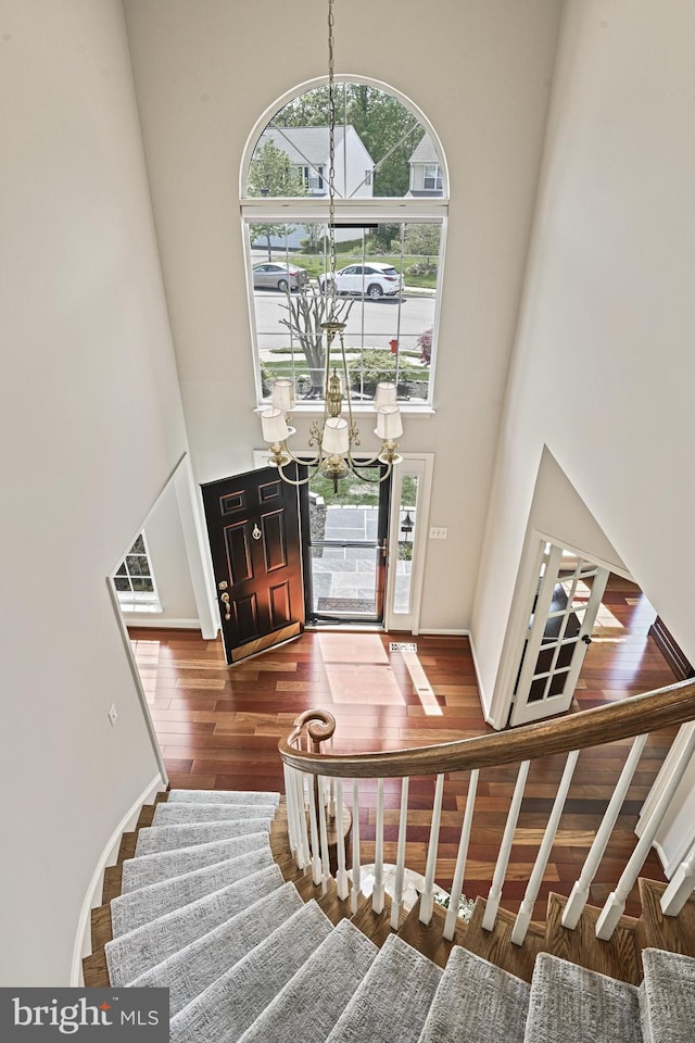 815 Kenneth Pl SE, Leesburg, VA 20175 - entrance foyer with stairs, wood finished floors, a towering ceiling, and a notable chandelier