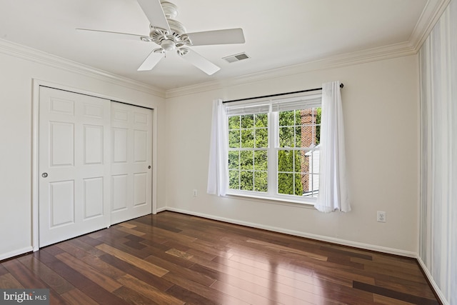 815 Kenneth Pl SE, Leesburg, VA 20175 - unfurnished bedroom with a closet, crown molding, visible vents, baseboards, and dark wood-style floors