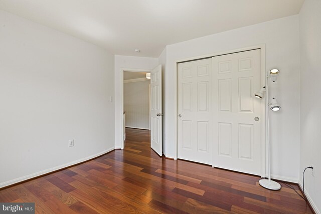 815 Kenneth Pl SE, Leesburg, VA 20175 - unfurnished bedroom with a closet, wood finished floors, and baseboards