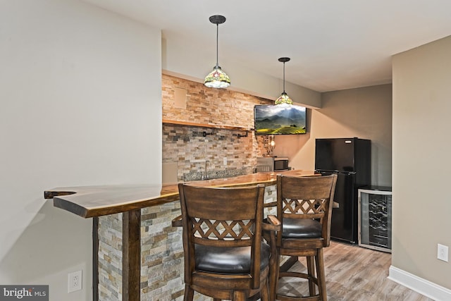 815 Kenneth Pl SE, Leesburg, VA 20175 - bar with beverage cooler, wood finished floors, indoor wet bar, freestanding refrigerator, and stainless steel microwave