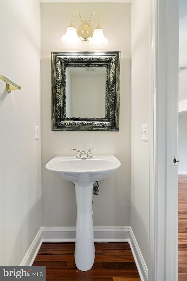 bathroom featuring baseboards and wood finished floors