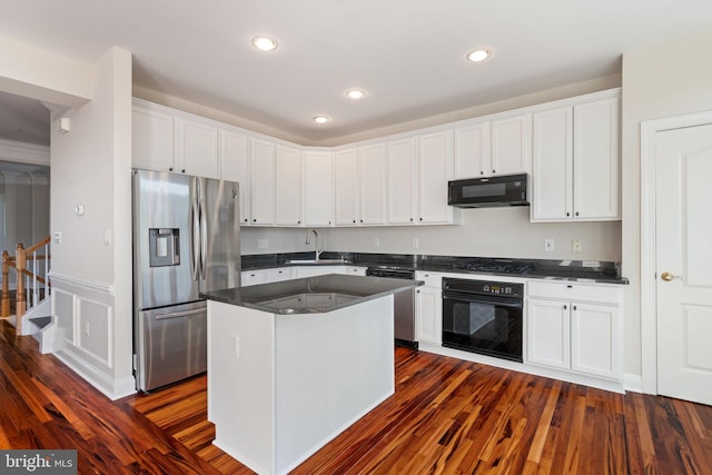 kitchen featuring white cabinets, a sink, a center island, dark wood-style floors, and black appliances