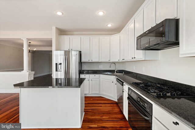 kitchen with a center island, white cabinets, black appliances, and recessed lighting