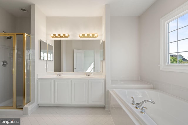 full bath with a sink, tile patterned floors, a shower stall, and a bath