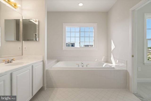 full bathroom featuring tile patterned flooring, recessed lighting, a garden tub, and vanity