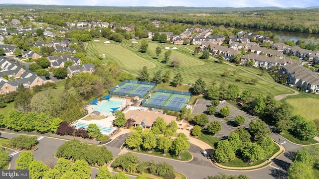 drone / aerial view featuring view of golf course and a residential view